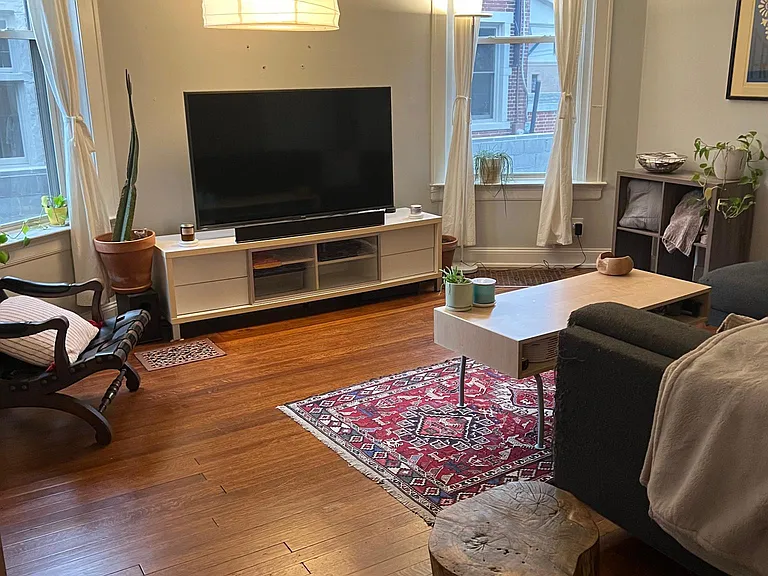 Living room with 12 foot ceilings and refinishing original hardwood floors