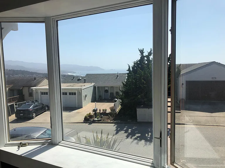 View of ocean, beach, and mountains - from dining room bay window