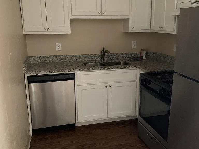 Kitchen area with dishwasher, refrigerator and stove