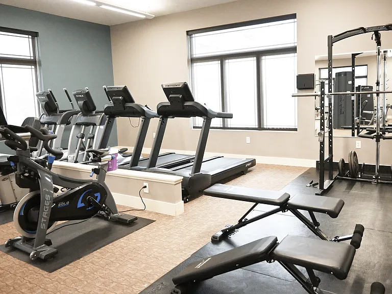 Treadmills and a stationary bike in the gym at The Sterling Kearney.