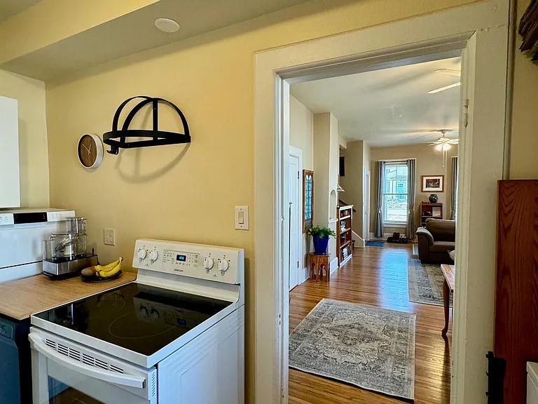 From kitchen looking into dining room / living room. Hardwood floors throughout.