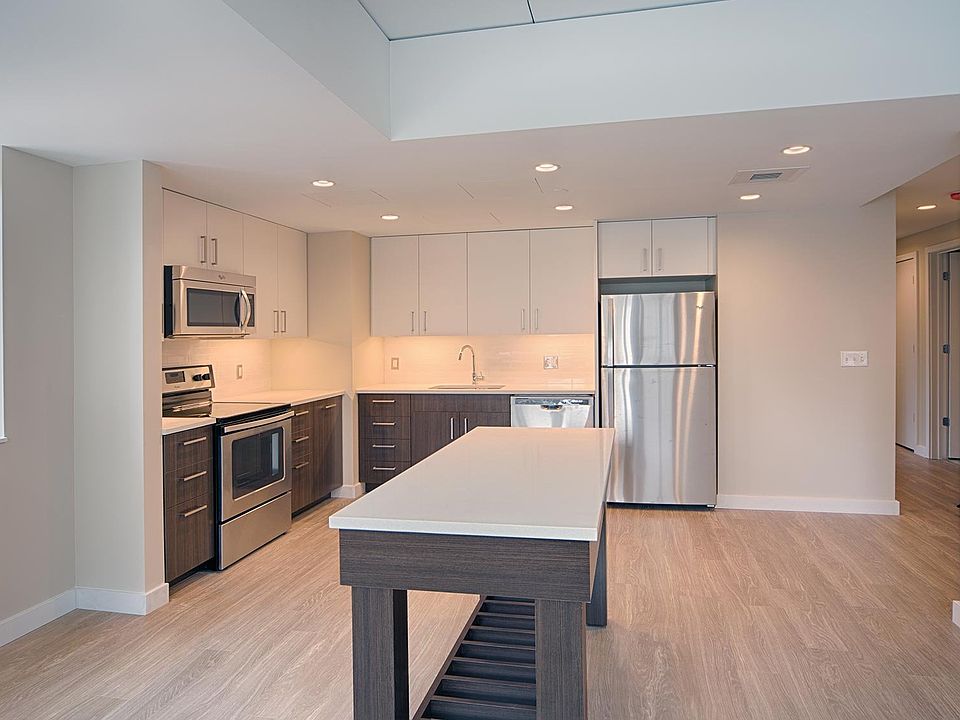Brand-new kitchens feature two-tone modern cabinets, quartz countertops and an island