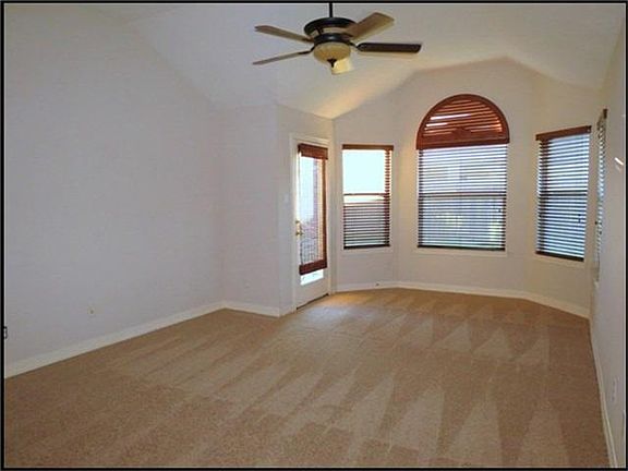 Master suite has bay window area, hi - ceilings and ceiling fan.