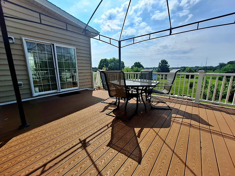 Take in the scenic views from the expansive deck, an inviting extension of the home's living space for dining or quiet relaxation