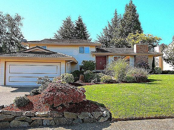 Lovely curb appeal with professionally landscaped yard.