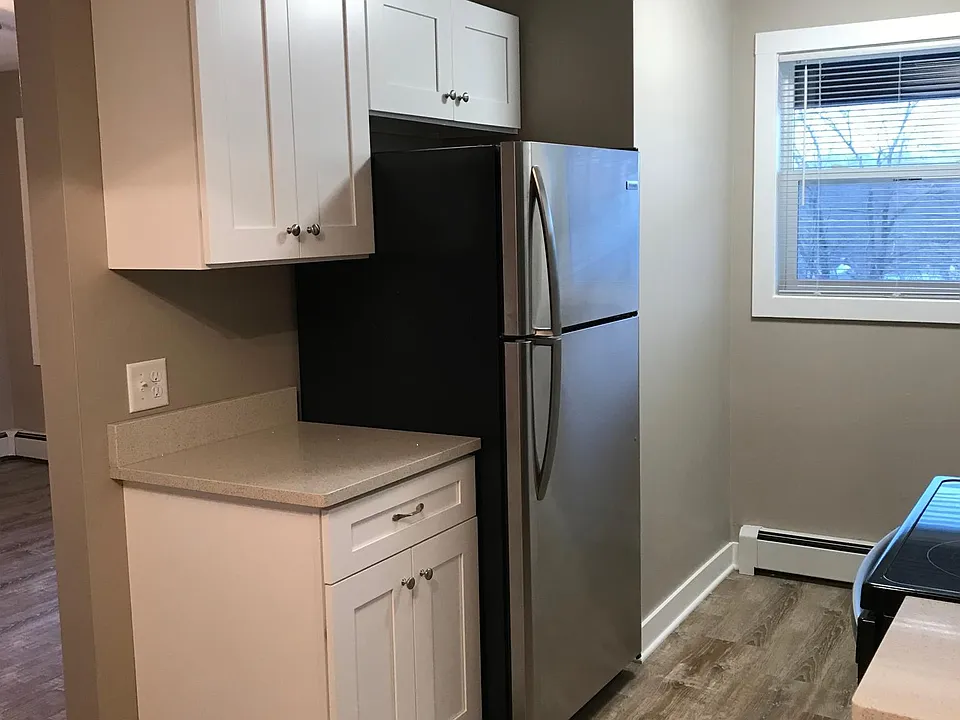 Additional counter space located next to the fridge.