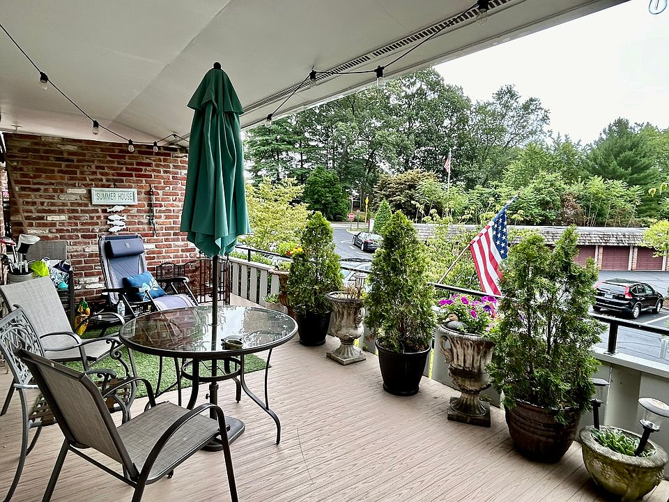 Can see the pool from deck but, ample space to sit day or night under overhang! This is a very large deck that adds a lot to unit. Bring your flowers! Large Evergreens will stay for added privacy. Two PINK dogwoods grace the view and a beautiful evergreen