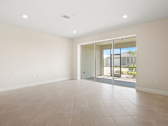 Spacious gathering room featuring sliding glass doors to the lanai