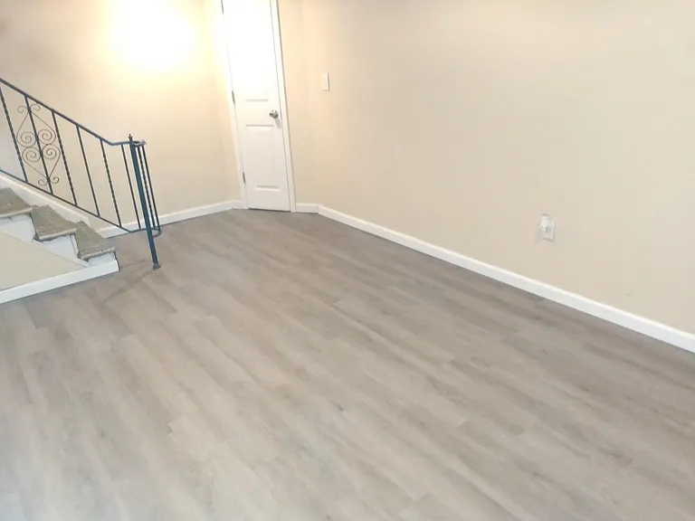 Large bedroom in basement with new flooring - rented