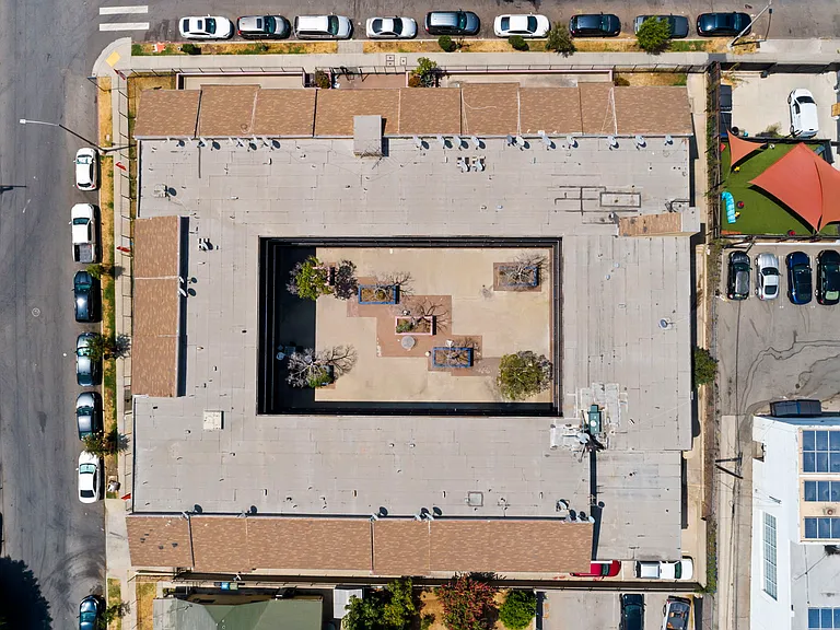 Bird's-eye view of the community featuring a central courtyard and surrounding parking.