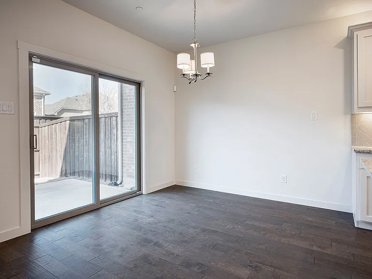 Rich hardwood floors complement this spacious dining area.
