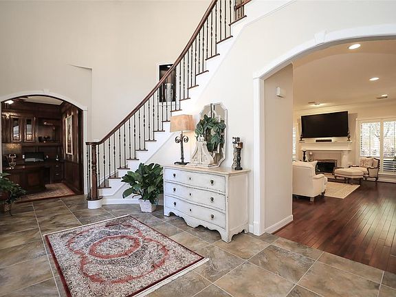 The entry is a real show stopper with the curved stairway, wrought iron railing and custom designed paint.