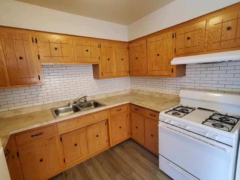 Kitchen with gas stove and refrigerator.