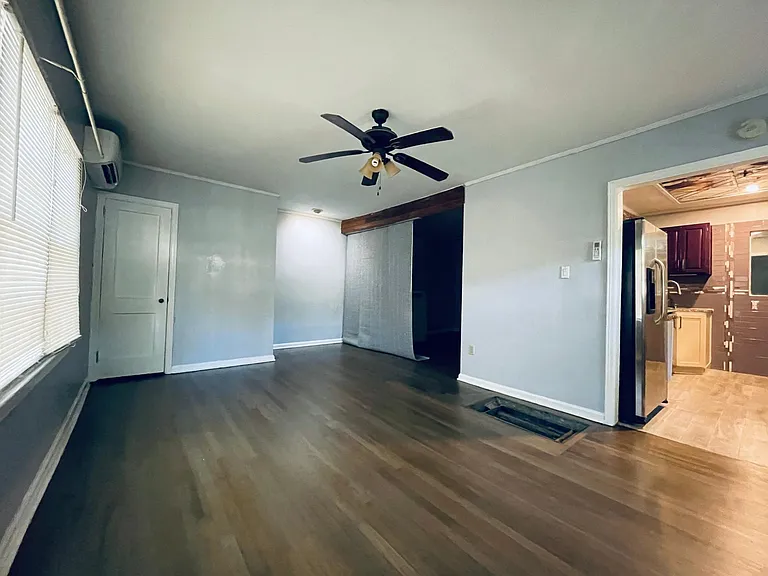 Living / Dining Room w/ folding wall to Bedroom, Gray Toned Hardwoods