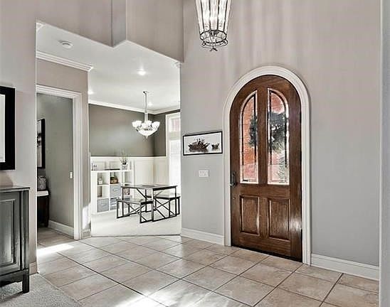 Enchanting Entry draws you into Open Concept Floor Plan with Luxuriously Tall Ceiling Heights and a Modern Palette...