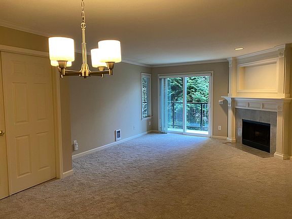 Large, open concept living area with fireplace and access to deck
