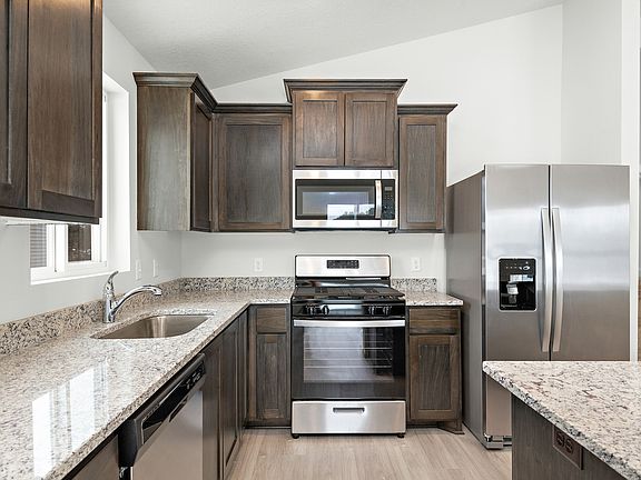 The kitchen is chef-ready with stainless steel appliances