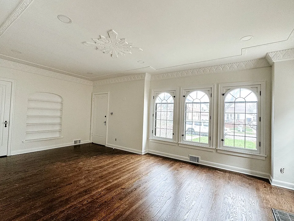 Bright and sunny family room with refinished original hardwood flooring.