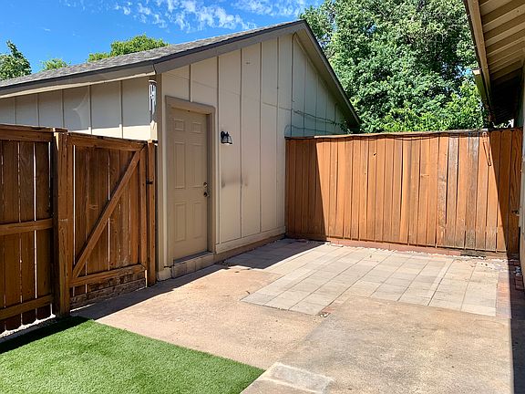 Paved back patio with artificial turf. Detached single car garage.