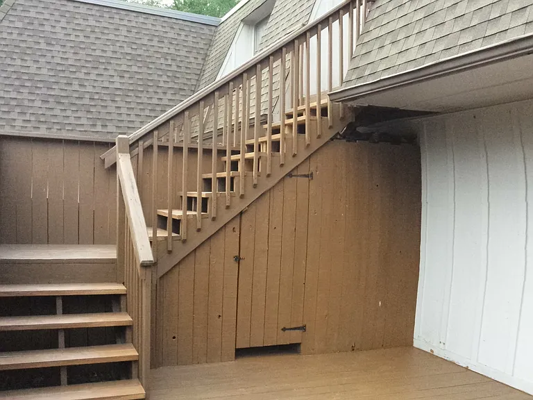 stairs to apartment with storage below