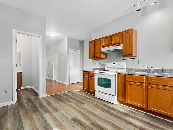 Kitchen. Range, Dishwasher, Refrigerator. Half bath to left.