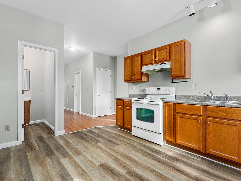 Kitchen. Range, Dishwasher, Refrigerator. Half bath to left.