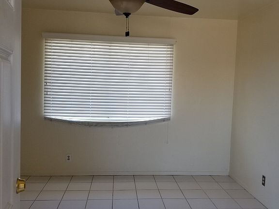 Living room with 52 inch ceiling fan and faux wood blinds