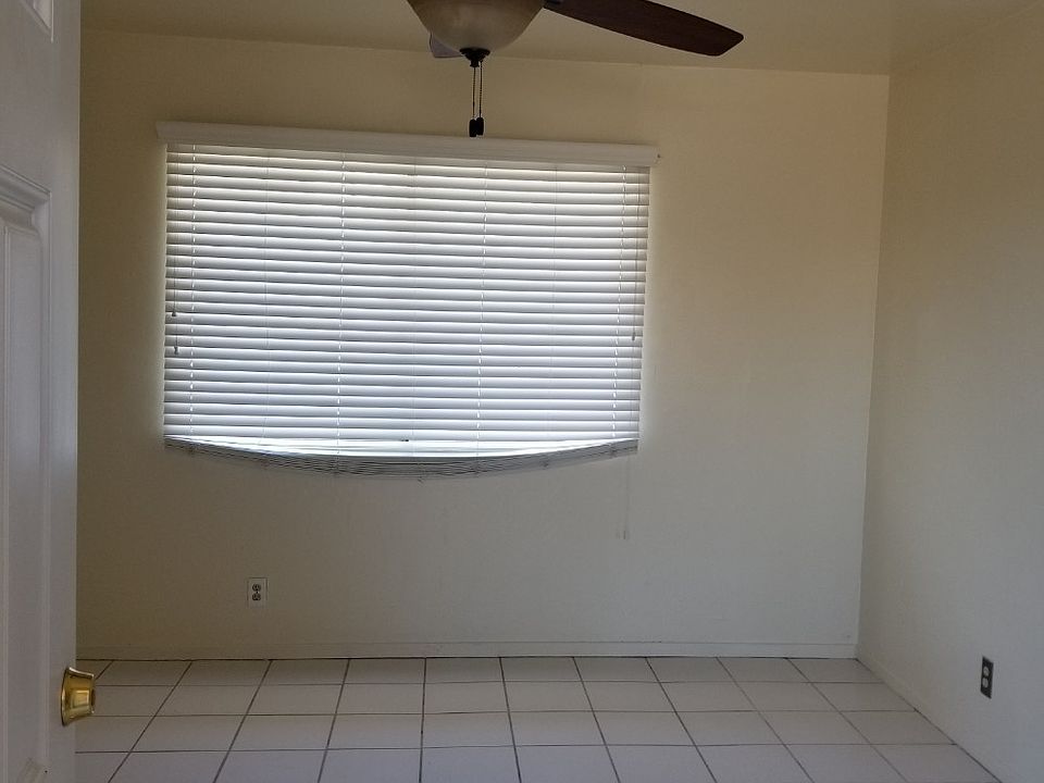 Living room with 52 inch ceiling fan and faux wood blinds