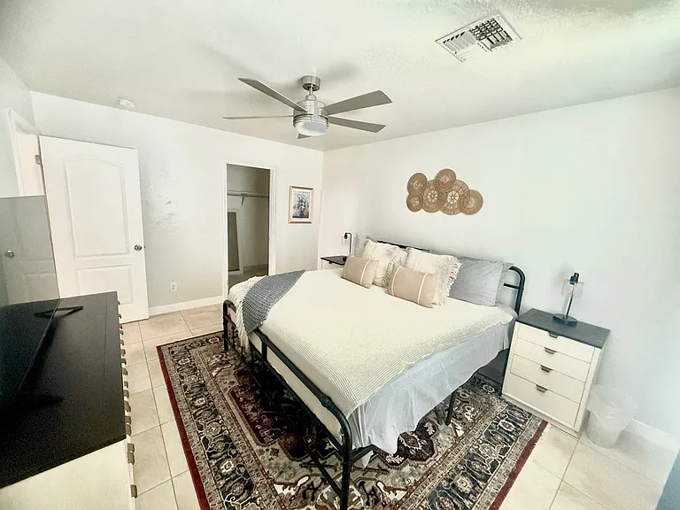 King Bedroom 1 with dresser, TV, walk in closet,