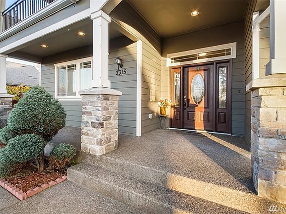 Covered front porch area adorned with stoned columns 