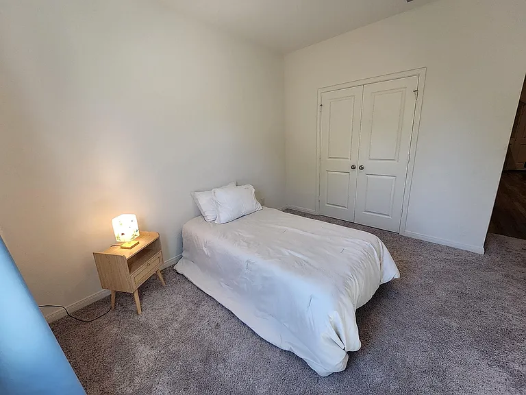 This bedroom is nice and cozy with a nice view of the backyard.