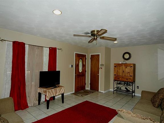 The front door opens to tile flooring in the living room.