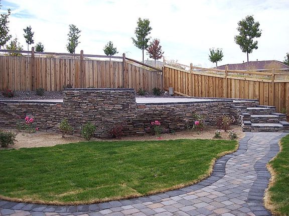 Raised paver/stone patio in the back