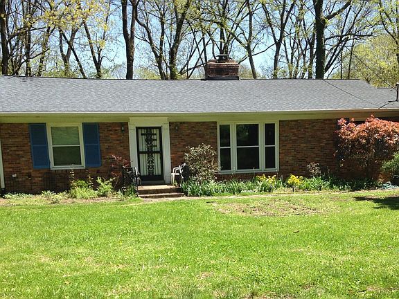 Front of house, with wooded one acre lot