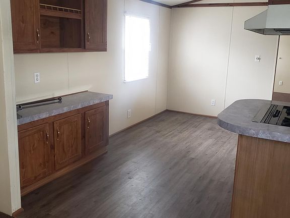 Standing in Living room looking at beautiful Plank flooring in kitchen and dining area