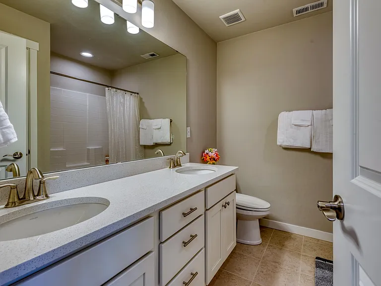 Upstairs Hallway Full Bathroom with double vanity sinks