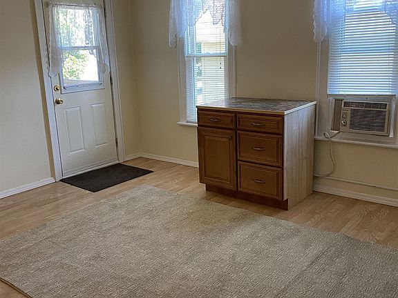 Your living room with new area rug and storage cabinet/TV st