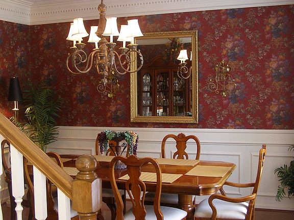 Hardwood dining area with beautiful paneling & dental molding
