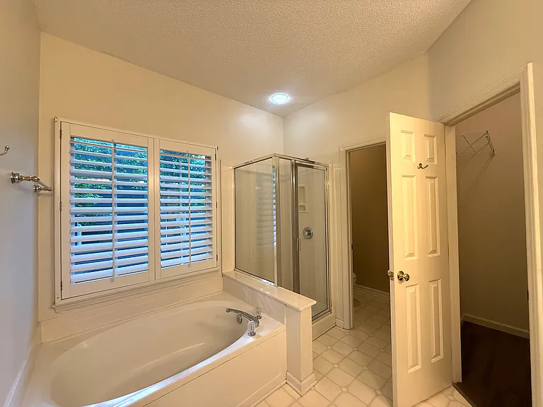 Masterbath plantation shutter window, bathtub and shower