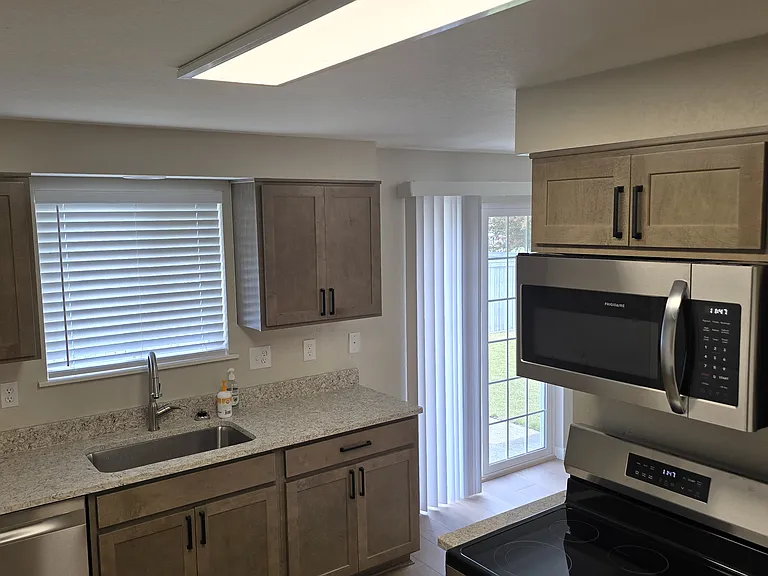 Dishwasher, microwave, stove, refrigerator. Sliding door to large backyard