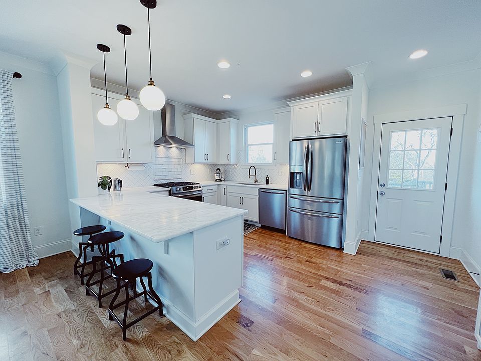 The spacious kitchen is a chef's dream, featuring high-end appliances, sleek countertops, and ample storage. An open, thoughtfully designed space perfect for preparing meals and entertaining with ease.