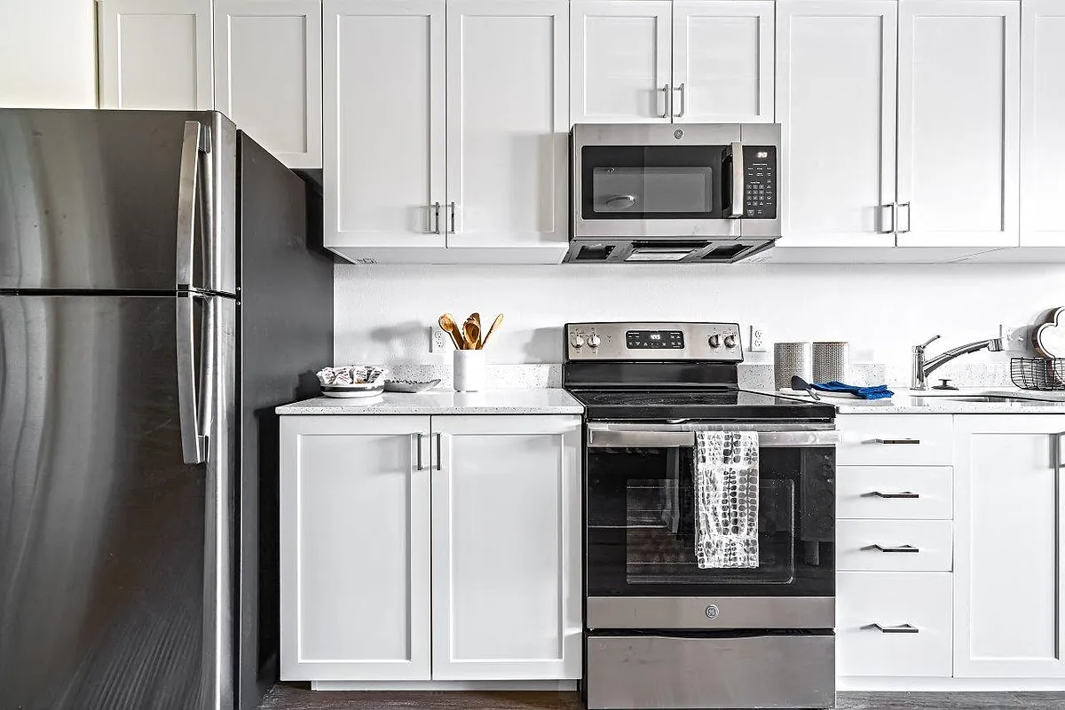 Bright kitchens featuring stainless steel appliances - The Eddy