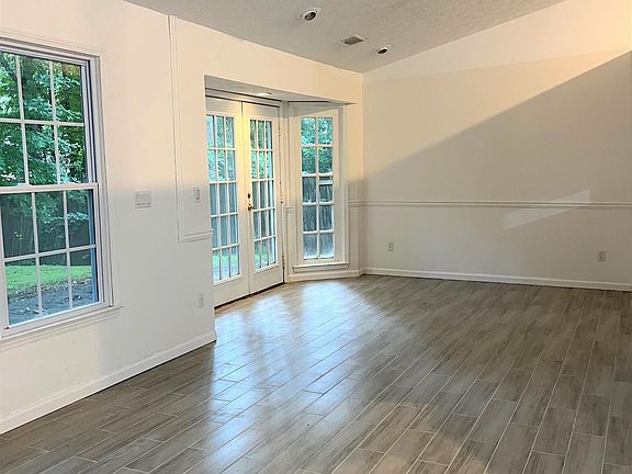 Dining room with French doors open to backyard.