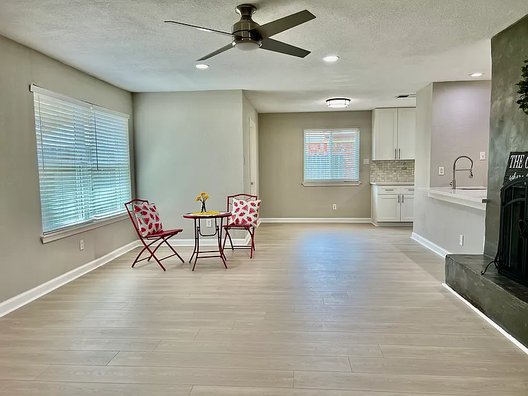This extensive family room offers a warm and inviting atmosphere, featuring a cozy fireplace as the focal point and seamless flow from the elegant wet bar_perfect for relaxing evenings or entertaining guests in style.