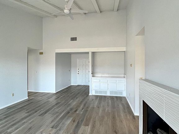 Living room view with gas fireplace and wet bar.
