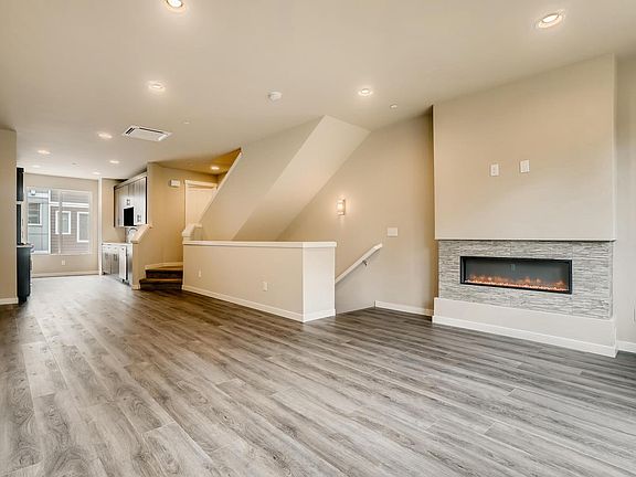 Open living space with heating/colling system, and modern fireplace.