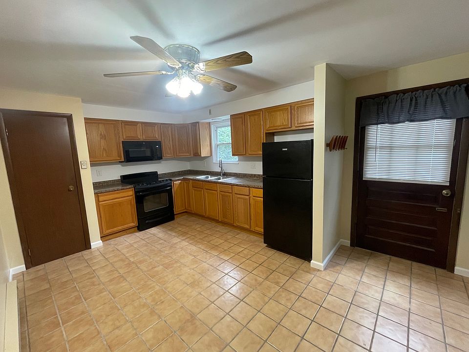 Kitchen with pantry and entrance door.