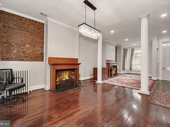 Large ballroom LR/DR with 2 columns, 2 FP & sparkling cherry hardwood floors with retro Chandelier & recessed lights.