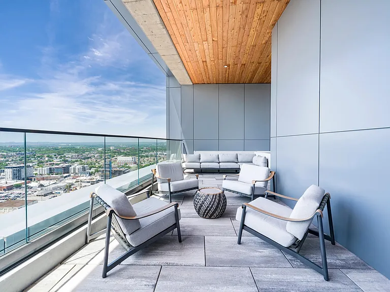Rooftop terrace with skyline views, covered seating, and comfortable lounge furniture designed for conversation, fresh air, and Nashville views.