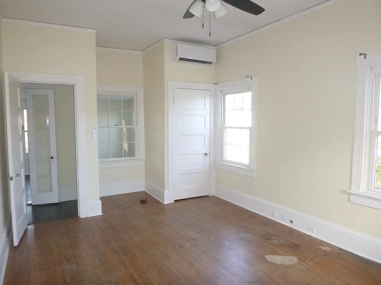 Spacious second bedroom (11x 19) features high ceilings, natural light, hardwood floors, ceiling fan and closet.